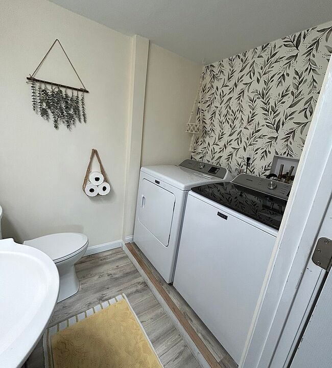 1/2 bathroom on first floor with laundry hook up. Dryer/washer is not included.