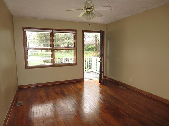 Living room has large windows, 2" blinds & hardwood floors