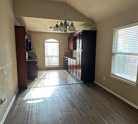 kitchen with tile flooring; dining area with premium vinyl plank flooring