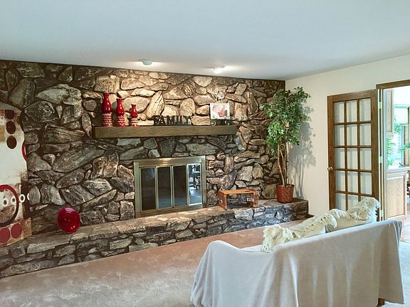 GAS BURNING FIELD STONE FIREPLACE IN FAMILYROOM