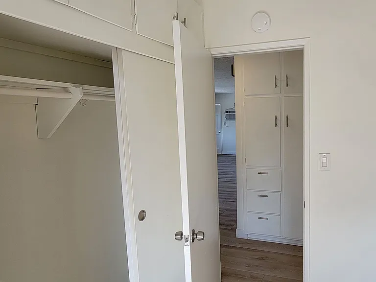 Large bedroom closet and hall closets in 2-bedroom apartment at the Hardison Apartments in Pasadena, California.