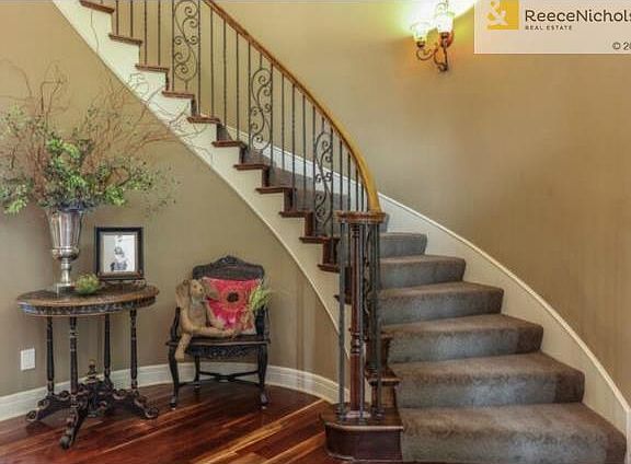 The grand entrance greets you with a beautiful curved staircase finished with wood end caps and wrought iron spindles.