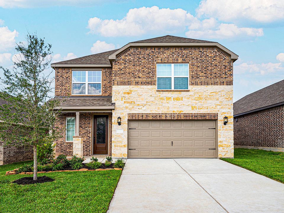 This beautiful two-story home has brick and stone and front yard landscaping