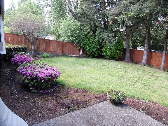 Back yard is fully fenced and has a storage shed and tasteful landscaping