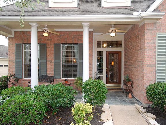 Cozy front porch is great spot to read a book or watch kids ride bikes in cul-de-sac.