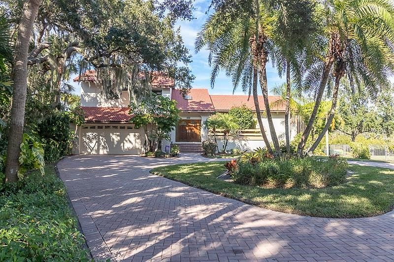 Long, circular paver driveway, extended 2 car garage w/workshop/extra storage