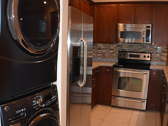 Full size front loading Samsung washer and dryer set, stainless steel appliances