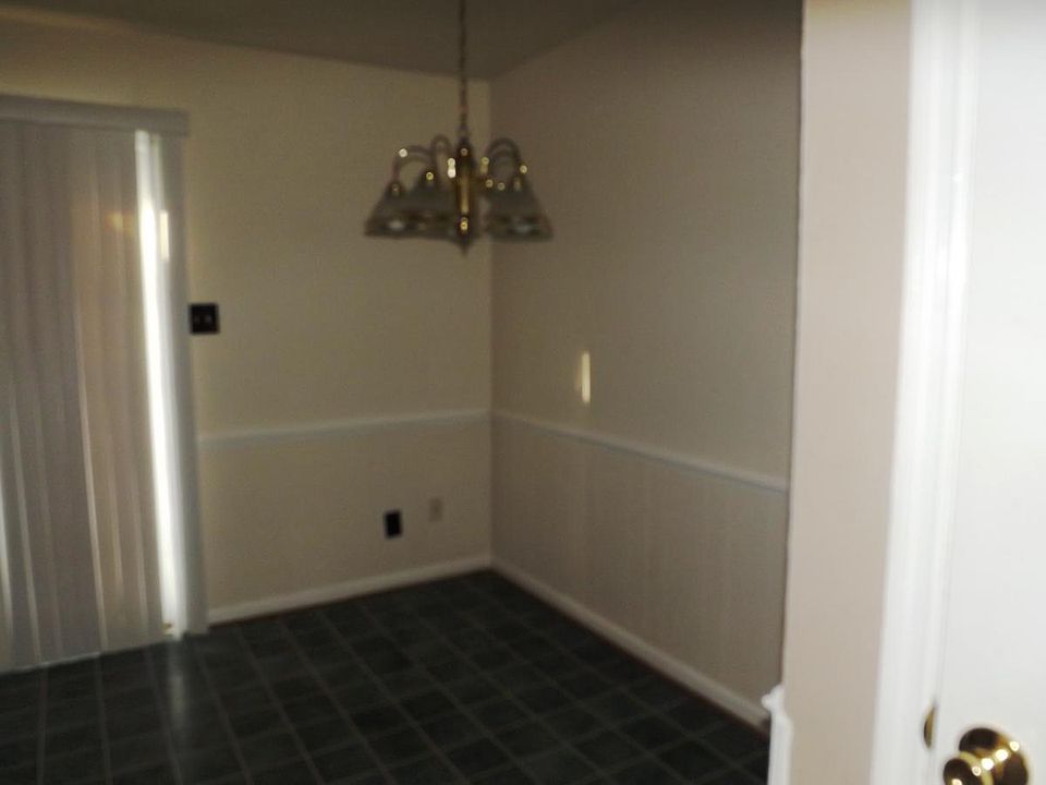 Large Kitchen has an eat in nook with chair rail.