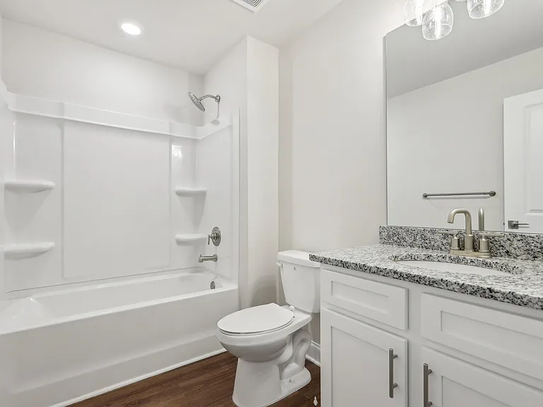 Secondary bathroom with tub shower and single vanity.