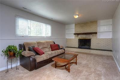 Family Room with cozy wood burning fireplace, bookshelves and