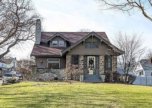 Front of home from street. Large front yard and beautiful stone columns.