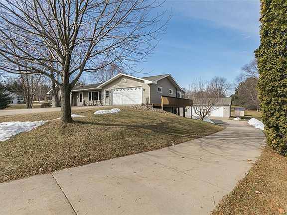Paved drive leading to the large detached heated workshop.
