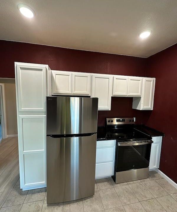 Left side of the kichen. On the left is hall to the back door. New appliances in the kitchen.