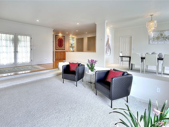 View from the formal living room toward the double French door entry and formal dining room.