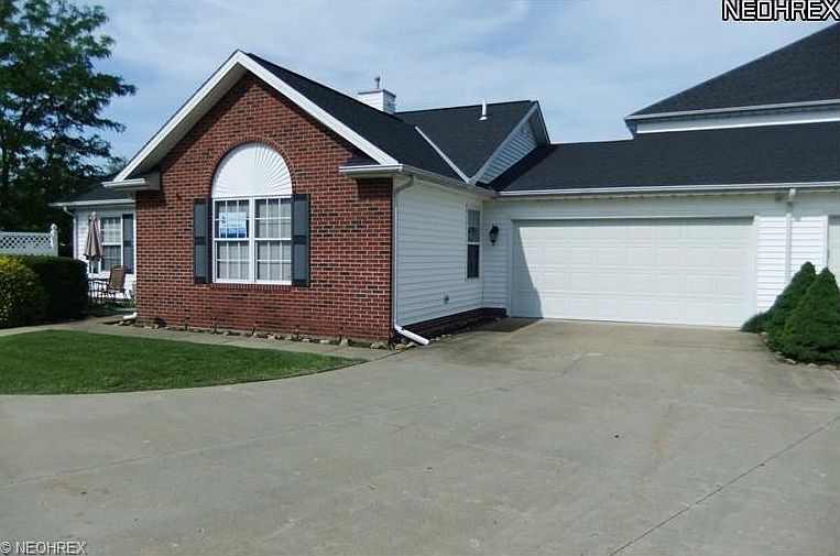 Front View of Condo with Front Concrete Patio and Oversized 2 1/2 Car Garage.
