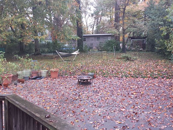 large gated parking pad in backyard