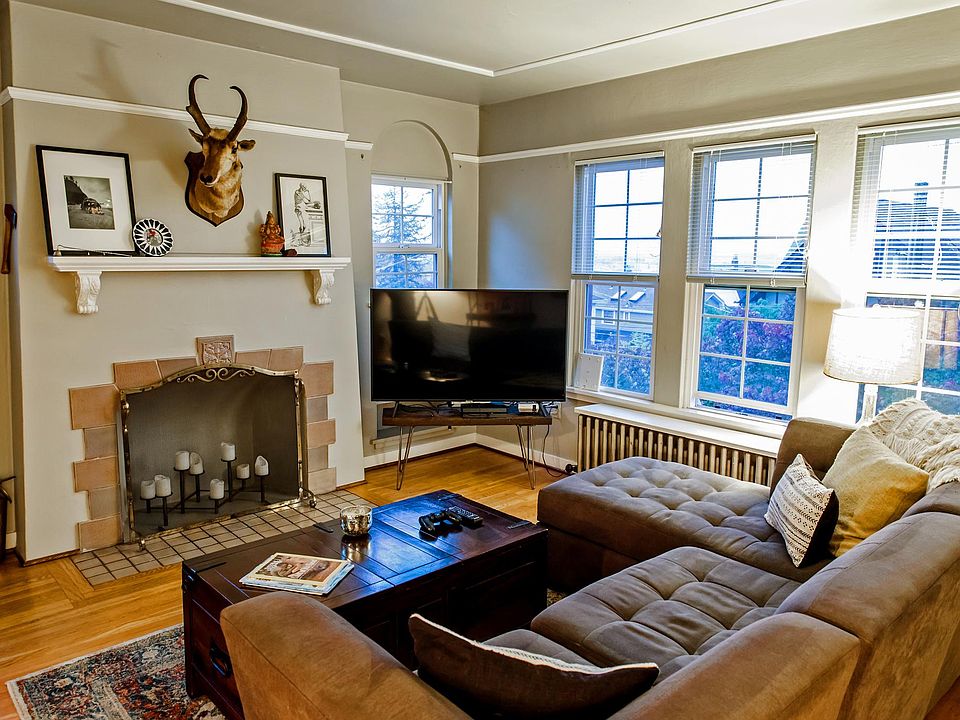 Living room with views of the Cascade Mountains and sweeping territorial views, decorative fireplace