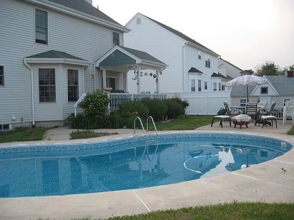 Private Backyard With Pool and Doll House Shed