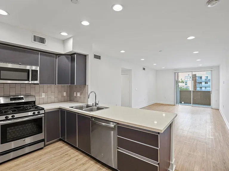 Open-Concept Kitchen, Dining, and Living Room Spaces with Patio