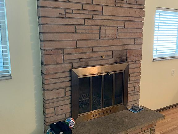 wood burning fireplace in bottom den