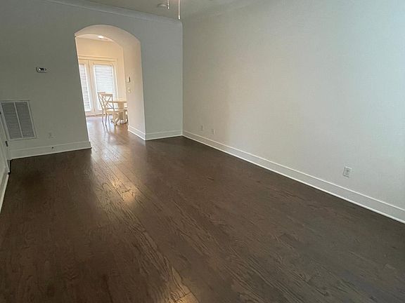 View from the front door of the roomy living room, looking into the kitchen