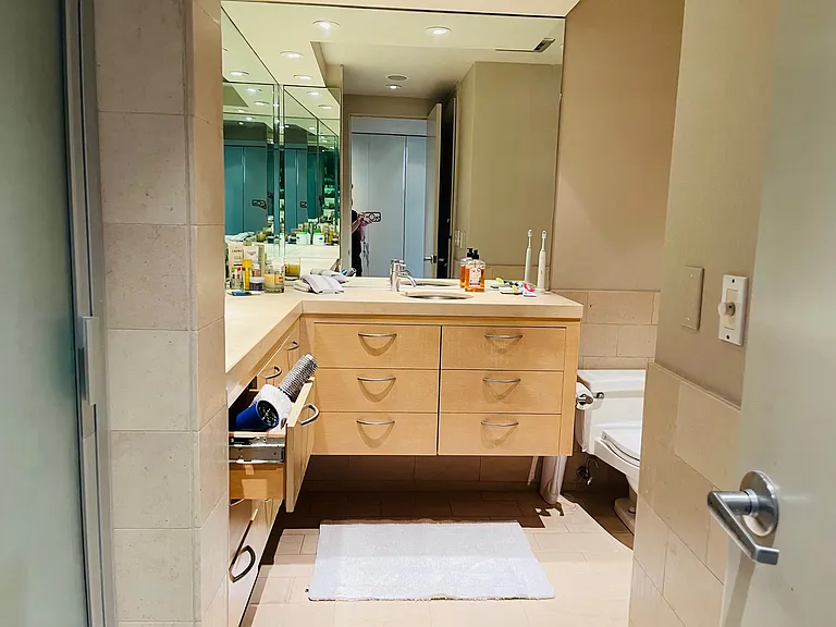 Lime stone master bath with bathtub and shower