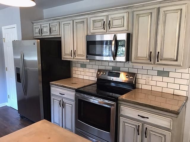 Custom painted plentiful cabinets in the kitchen!