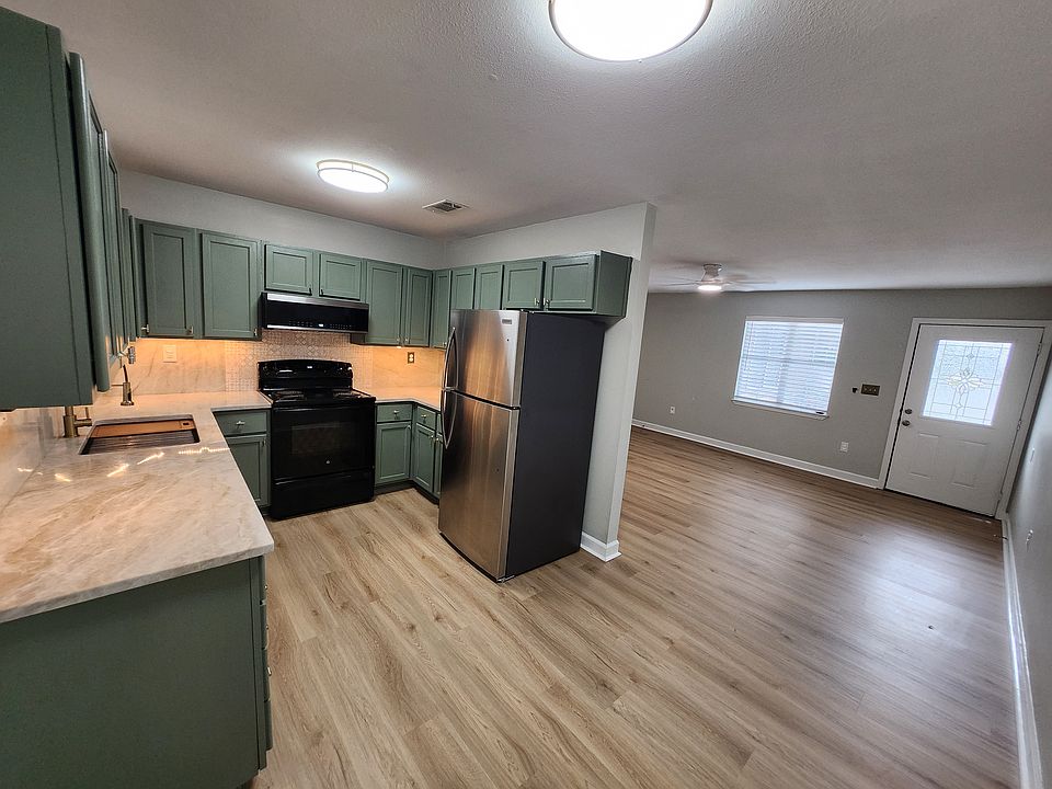 OPEN PLAN KITCHEN/ LIVING AREA, VERY BRIGHT LED FLUSH MOUNT LIGHT FIXTURES. UNDER COUNTER LIGHTING. NEW FRIDGE AND LOW-PROFILE MICROWAVE, WORKSTATION SINK WITH BUILT IN CUTTING BOARD AND DRAINER, PLUS COLANDER