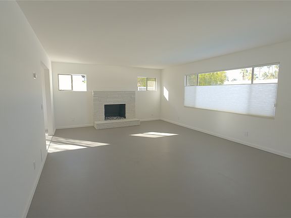 Living room with fireplace and pool view