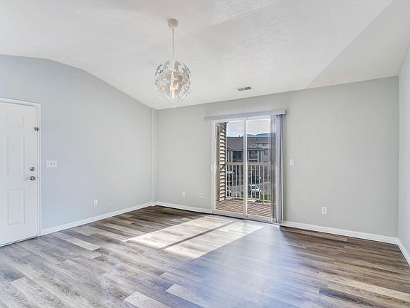 Family Room with access to balcony and storage room - notice the new floors and fresh paint!