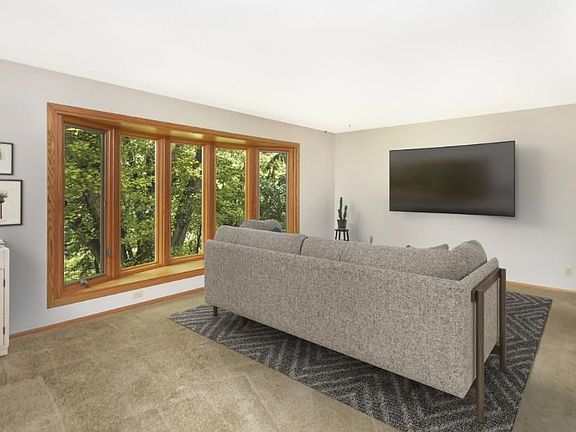 Huge living room over looks large wooded lot.