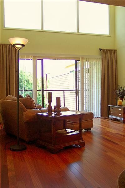 Living area with vaulted ceiling and large windows and glass