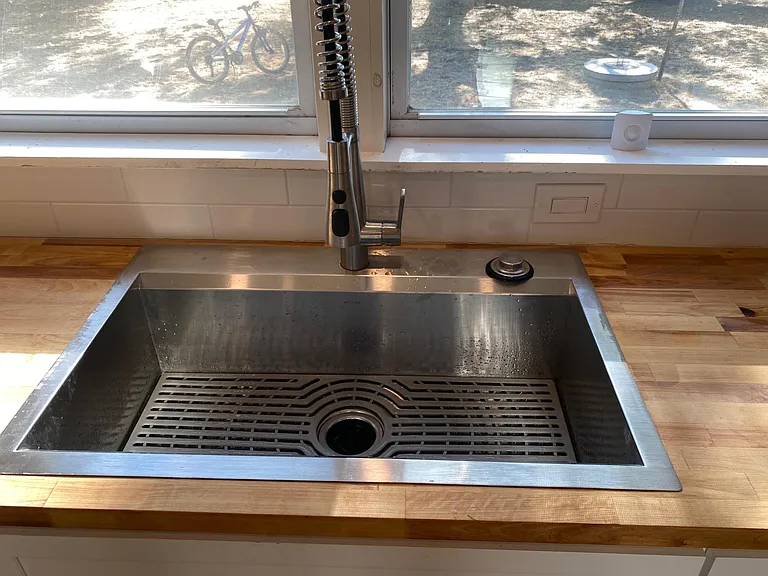 Stainless steel deep basin sink with new faucet and new American standard disposal.