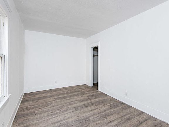 Bedroom with walk-in closet and wood plank style flooring at 4141 Normal Avenue in Los Angeles, California.
