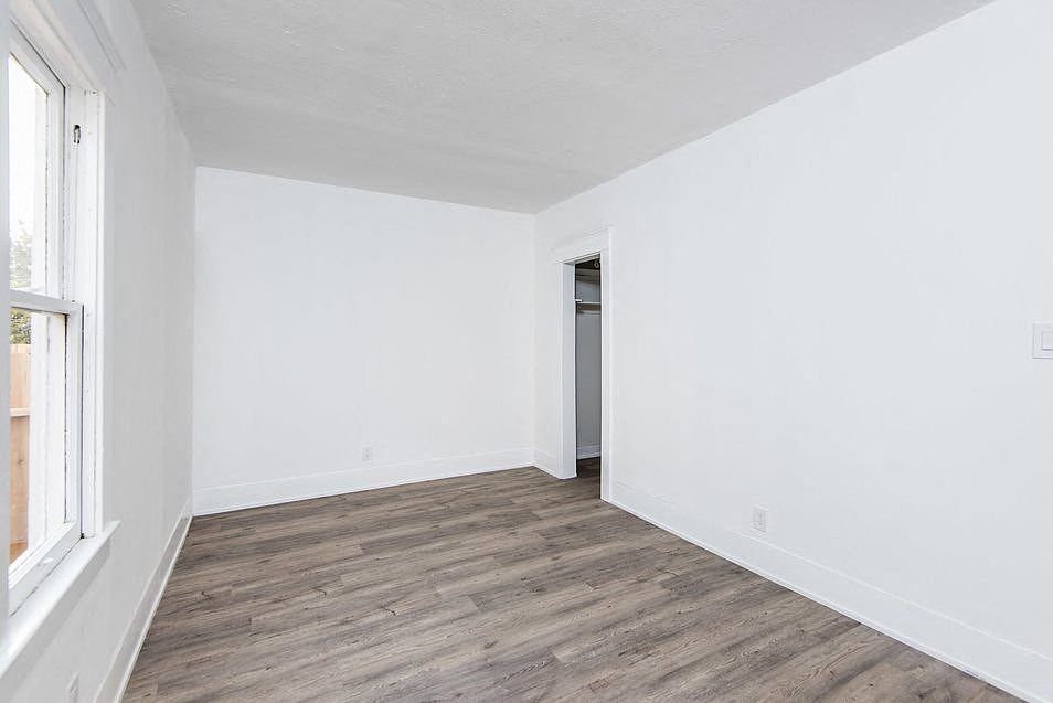 Bedroom with walk-in closet and wood plank style flooring at 4141 Normal Avenue in Los Angeles, California.