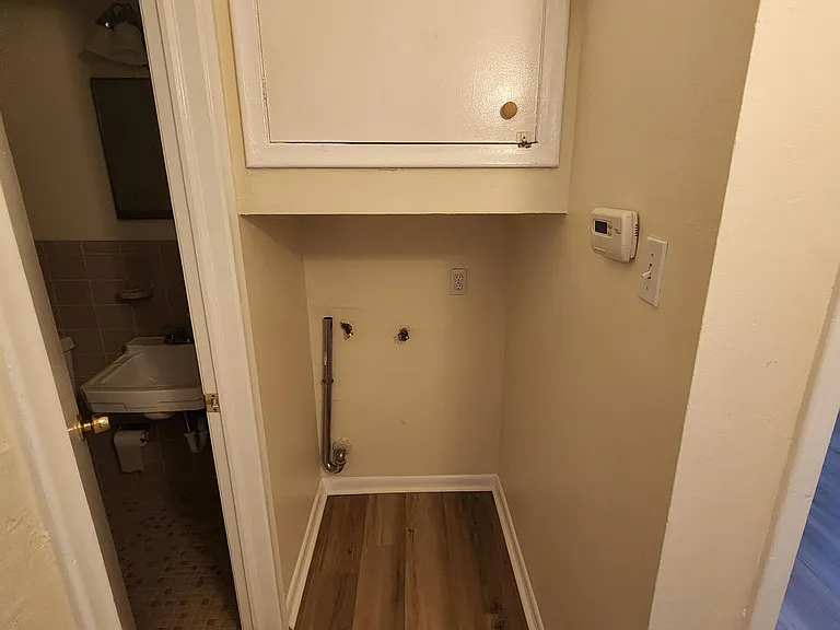 Access door to hot water heater and power and water hook ups for clothes washer