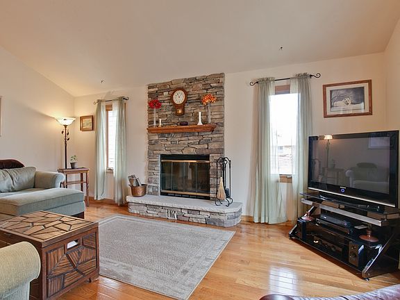 Bright and Airy Living Room, with Beautiful Stone Fireplace