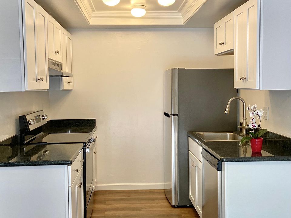 Newly renovated kitchen with new appliances, cabinetry, and granite countertops, and flooring.