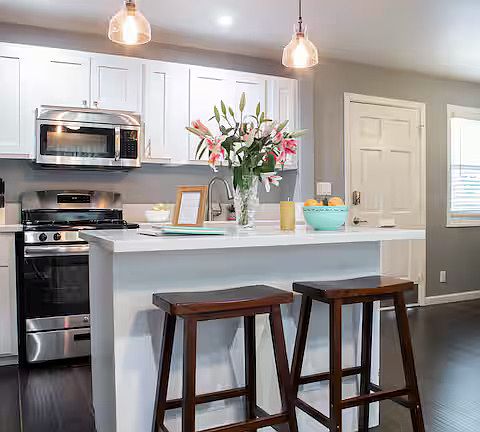 A fully equipped, sleek kitchen with state-of-the-art appliances, granite countertops, and all the essentials needed for preparing delicious meals.