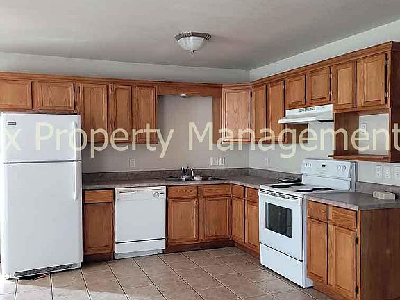 Kitchen with refrigerator, dishwasher, and electric range
