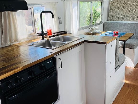 This is the kitchen area and the eating area. The stove has a faulty gas line so there is 2 cocking plates instead. The kitchen comes fully equipped with coffee maker, toaster, refrigerator & all kitchen items needed.
