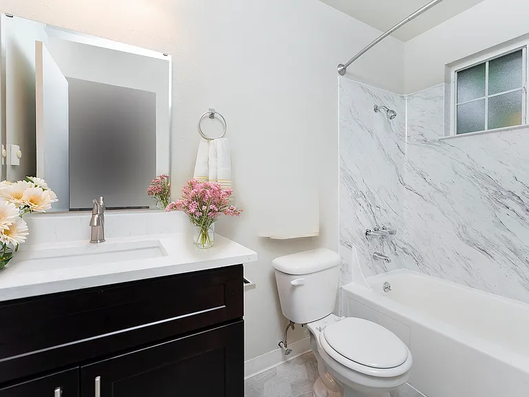 Experience luxury with this beautifully designed bathroom featuring marble accents and floral touches. Experience luxury with this beautifully designed bathroom featuring marble accents and floral touches.