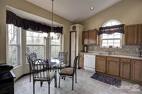 The kitchen has attention to detail and functionality unlike anything the competition has to offer. Take note of the cathedral ceiling and volume this space has to offer. Extra cabinets and a bay window will assure you have all the space necessary. Other features include tile backsplash, palladium window above sink, pass through ledge into the Great room, decorative lighting and a view of the wooded backyard. Set up a showing today and take advantage of this price and the amenities this home has to offer.