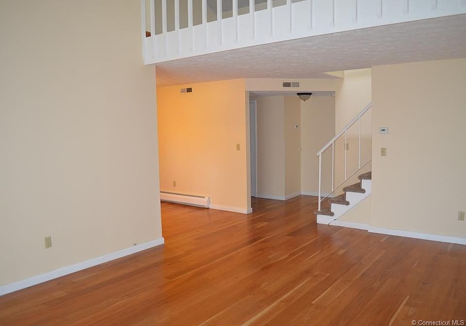 view from the living room to the loft area and dinning room
