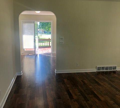 Large living room with arched entry into dining room. Walkout to a spacious deck