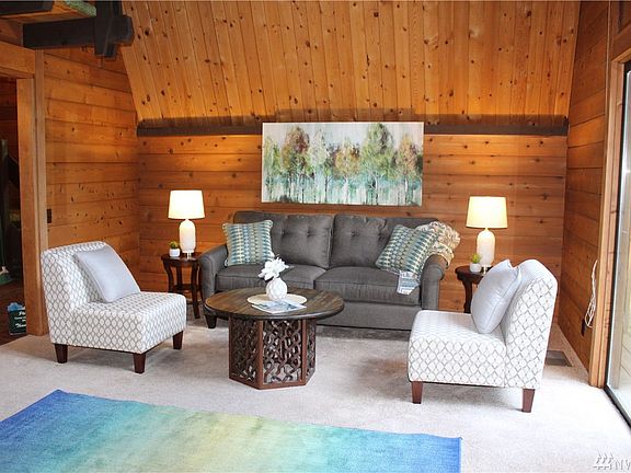 You won't find drywall here. This is a very roomy great room with floor to ceiling windows that lead out to a deck.