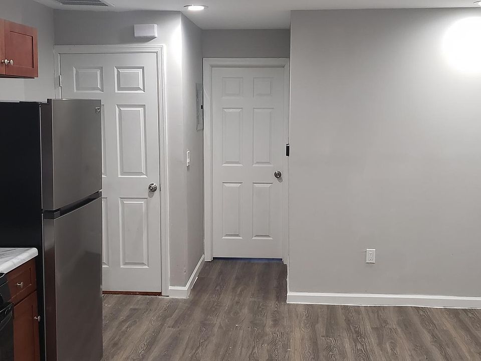 View of front door and front bedroom door from kitchen
