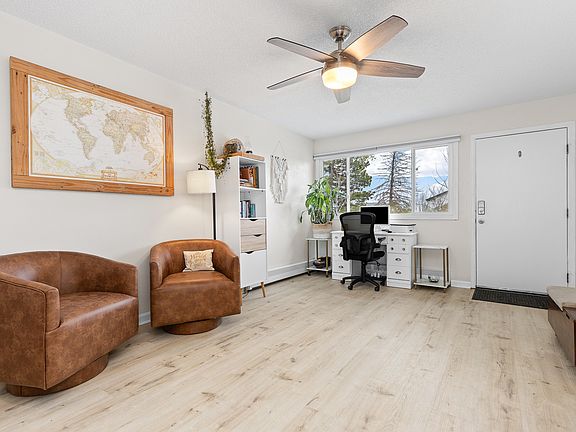 Living room with new LVP floors, new ceiling fan, new windows