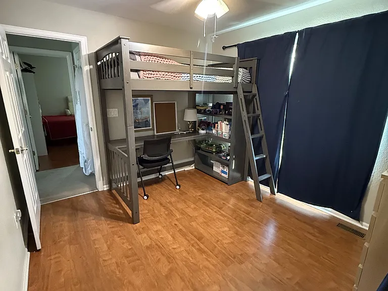 Third bathroom with large windows, ceiling fan, and a walk in closet.