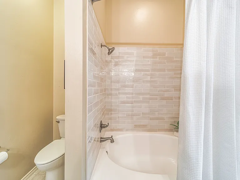 Garden tub with updated tile in primary ensuite